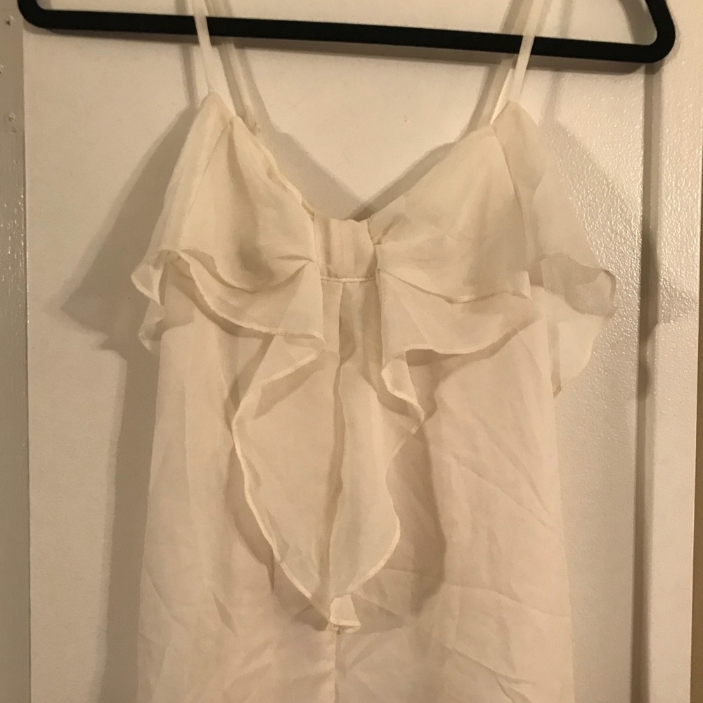 Cream tank top with bow on the front.
